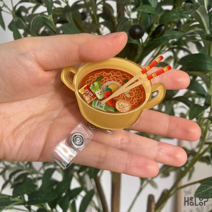 Korean Ramen Shaker Badge Reel – cute noodle pot design held in hand
