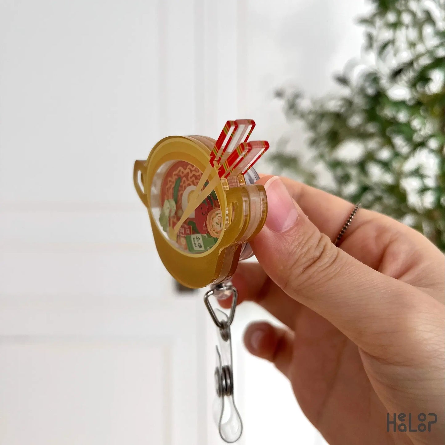 3D acrylic ramen badge reel showing detailed layers and chopsticks
