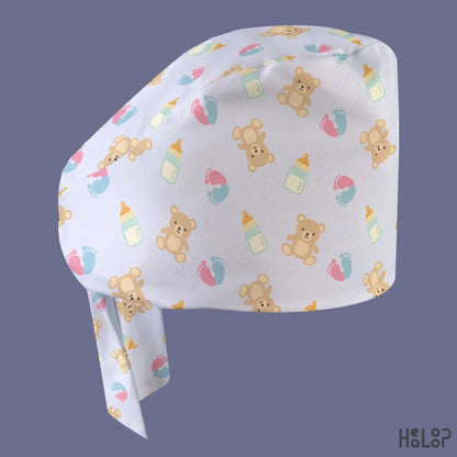 Teddy bear classic surgical scrub cap for NICU and labor and delivery nurses, featuring a light pastel background with baby bottles and colorful footprints.