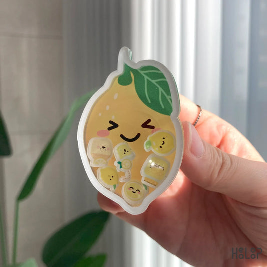 Hand holding lemon shaker phone grip with cute lemon details inside