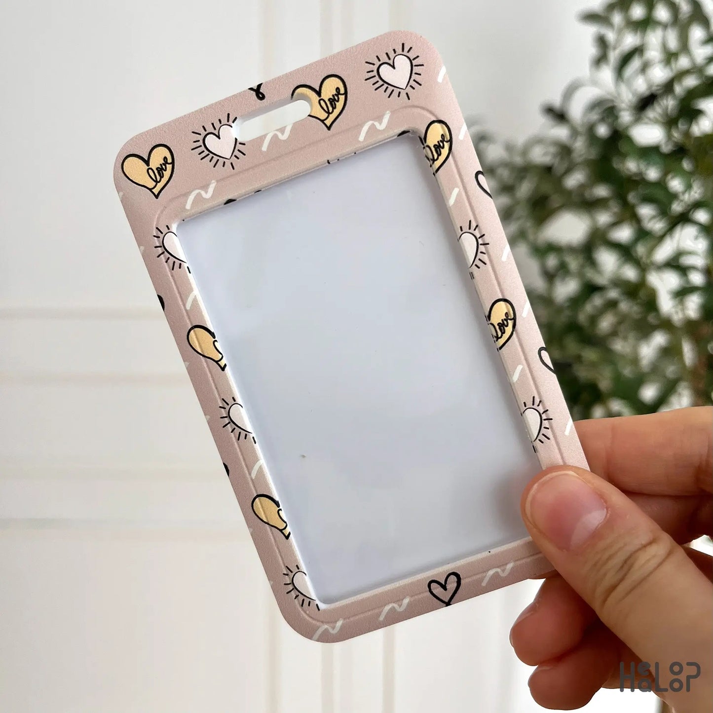 cute love heart ID badge holder in pink and yellow with playful “love” print front