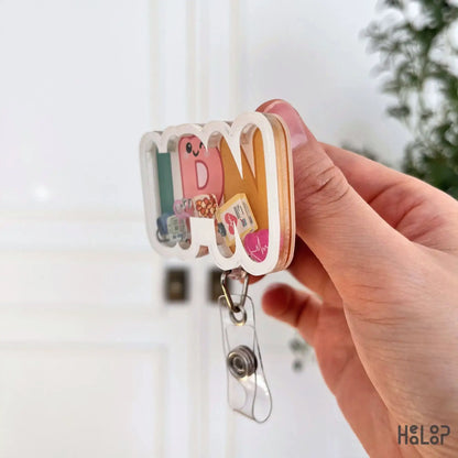Side profile of LPN shaker badge reel showing layered acrylic badge holder design