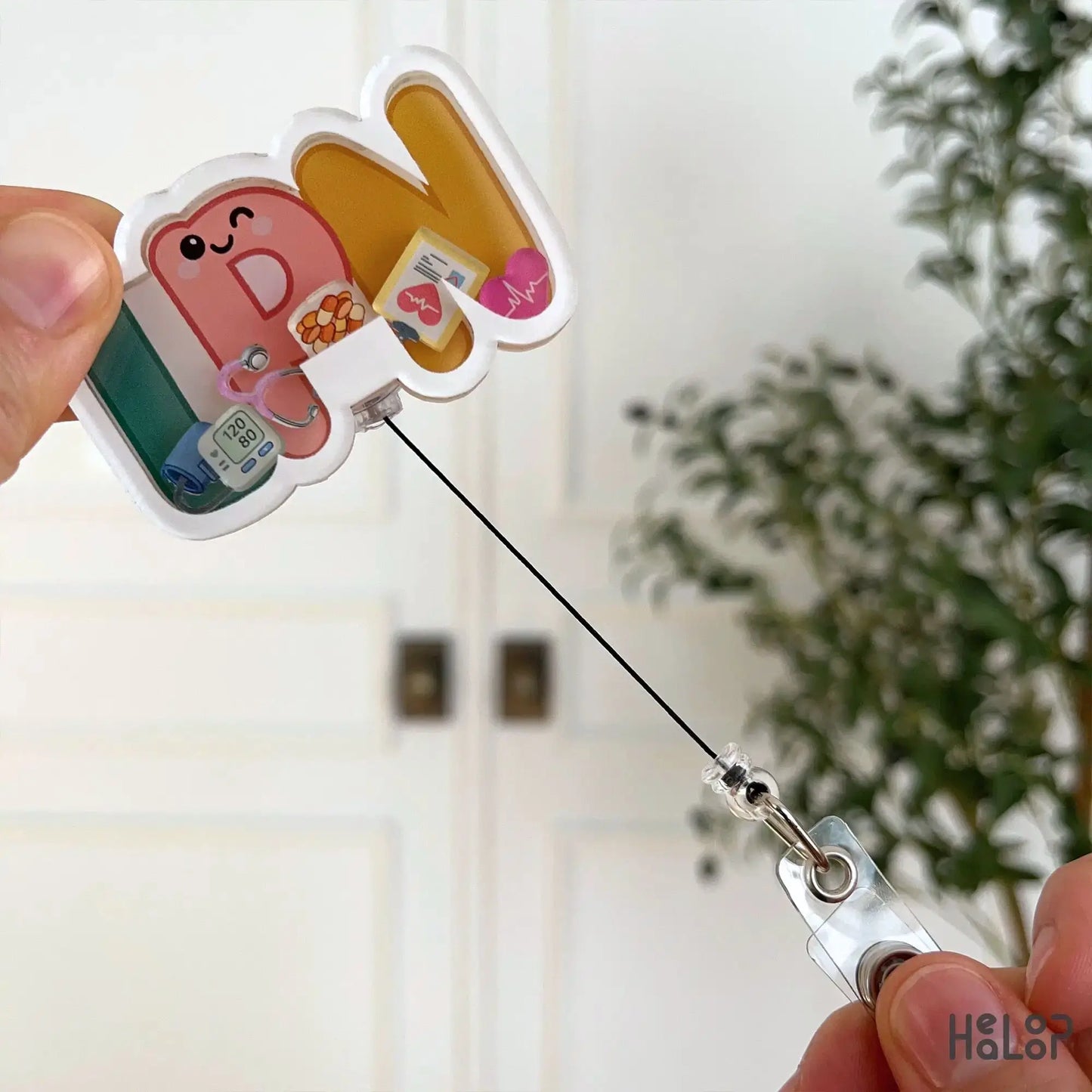 Retractable LPN nurse badge reel showing pull cord ID badge holder for healthcare workers