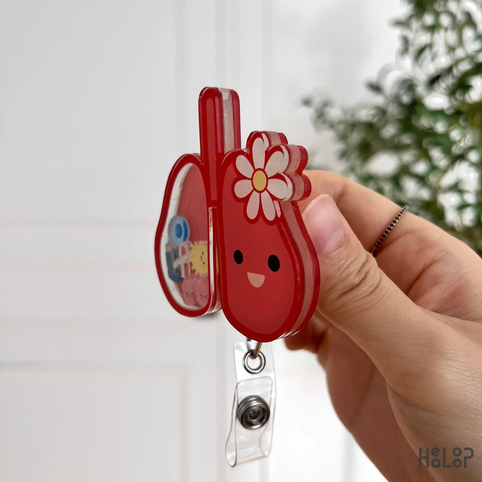 Lung shaker badge reel side angle showing layered acrylic and sturdy metal clip