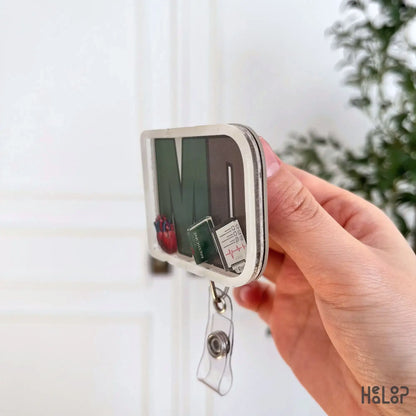 Side profile of MD shaker badge reel showing layered acrylic doctor badge holder
