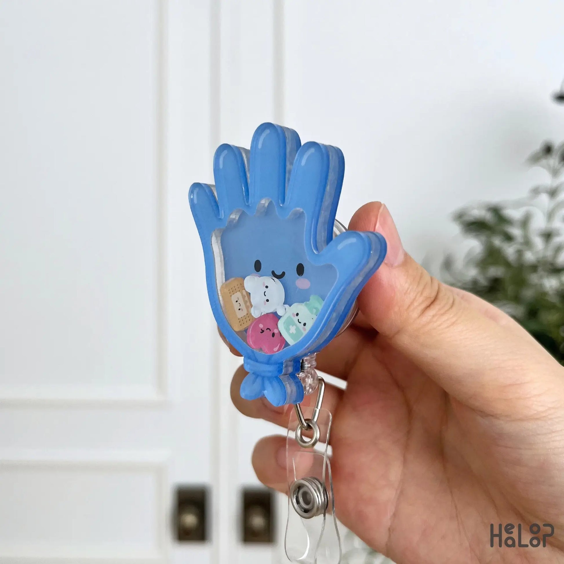 Side view of Medical Glove Shaker Badge Reel showing the layered acrylic construction and moving medical charms.