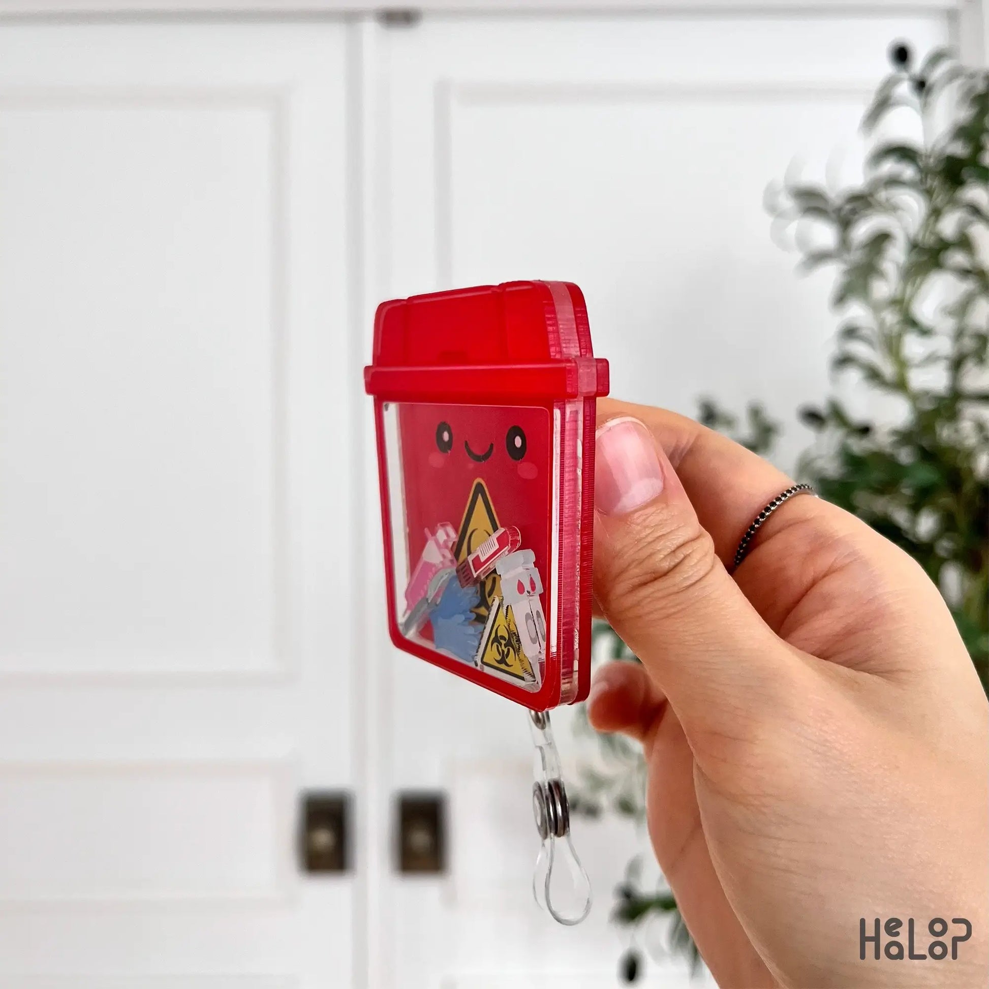Acrylic sharps container shaker badge reel shown from the side