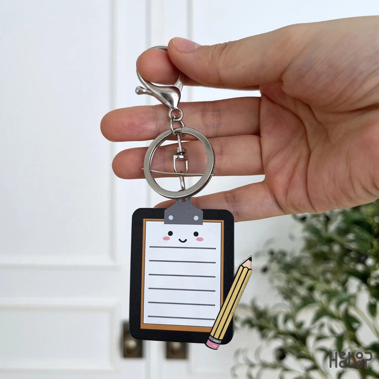 Back view of the Mental Health Board Keychain featuring a cute clipboard and pencil illustration.