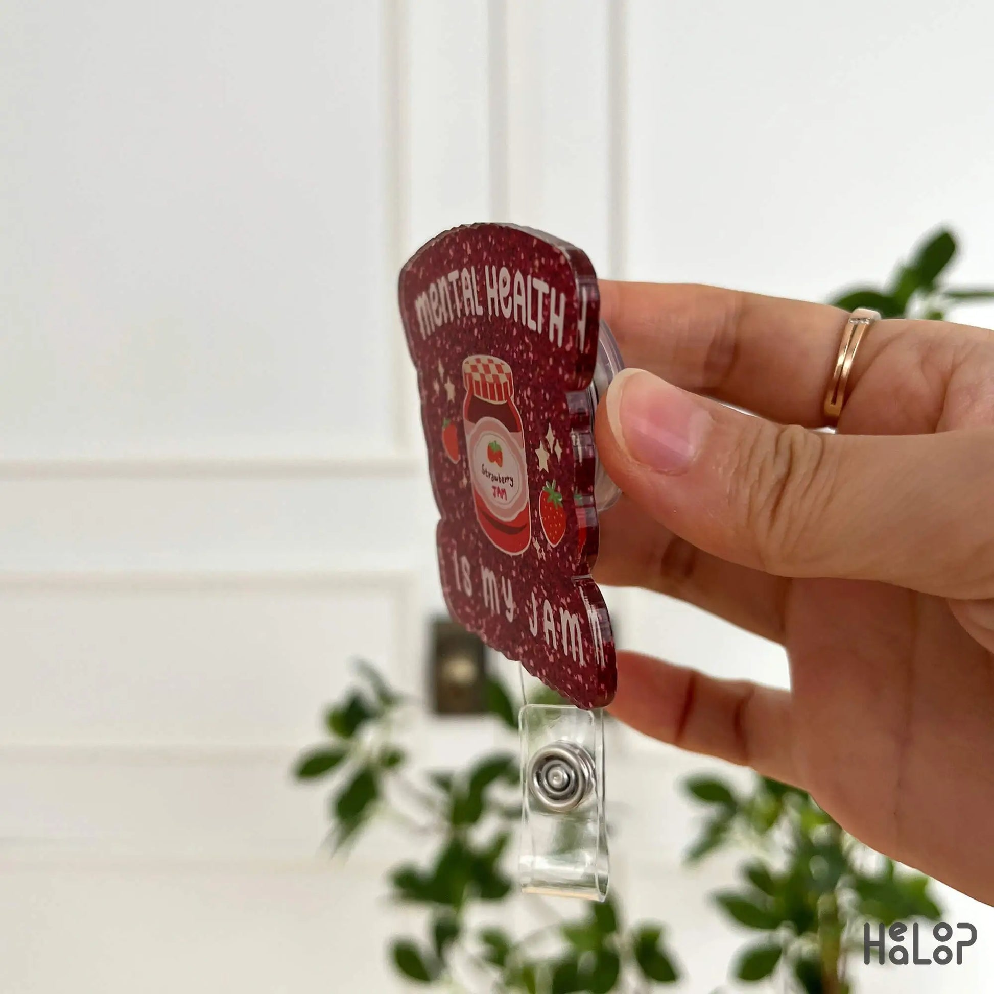 Side angle of red printed glitter-look badge reel showing durable acrylic material