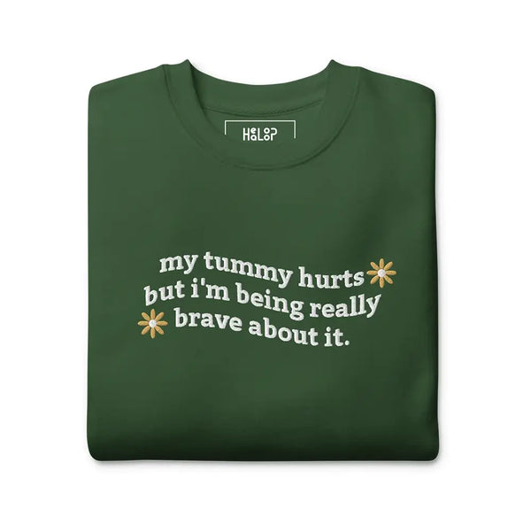 Folded My Tummy Hurts sweatshirt in Forest Green with embroidered text, 'My tummy hurts but I'm being really brave about it'