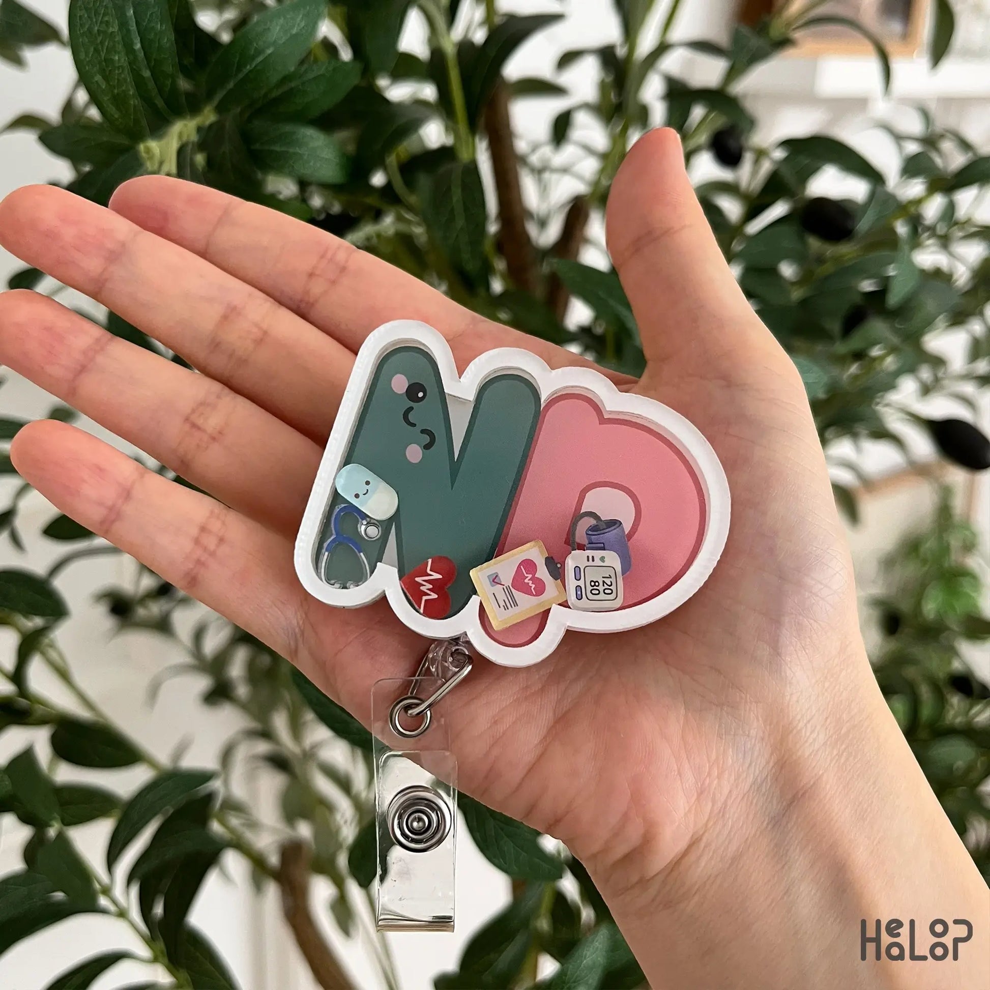 Cute NP Shaker Badge Reel for Nurse Practitioners featuring movable medical charms and retractable badge holder.
