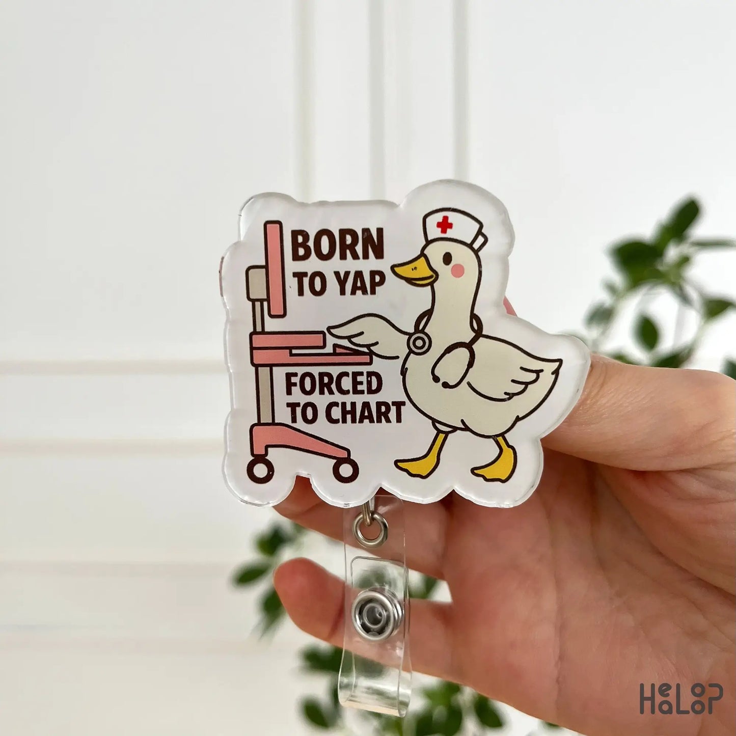 Front close-up of funny nurse badge reel – “Born to Yap, Forced to Chart” quote in pink tones by Healoop