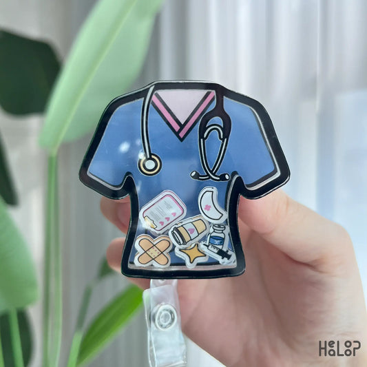 Close-up of cute nurse shaker badge reel with syringe, bandage, and clipboard charms on retractable ID holder.