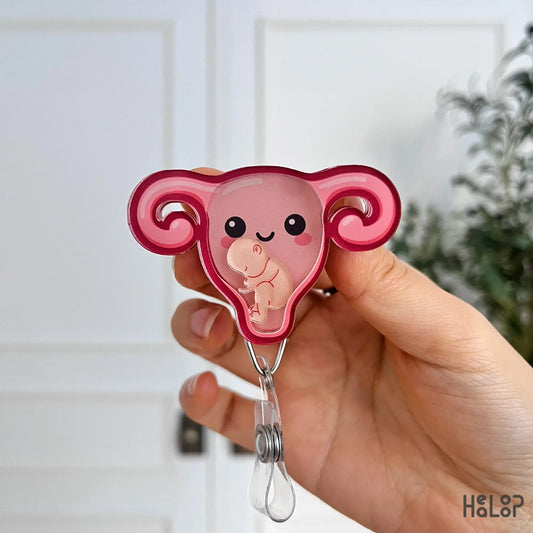 Front-facing OBGYN shaker badge reel featuring a cute uterus and baby figure.