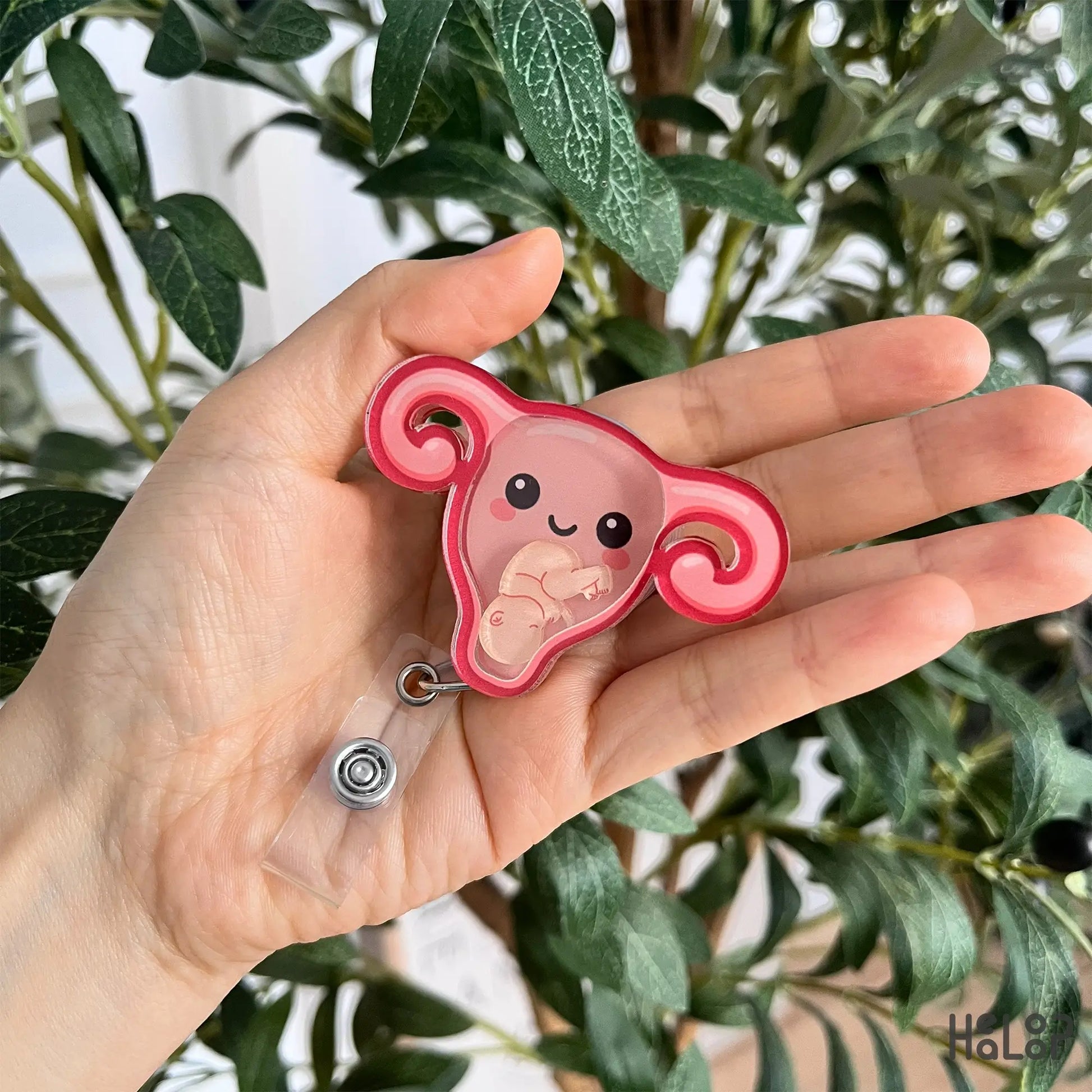 Handheld OBGYN uterus shaker badge reel with adorable baby charm inside.