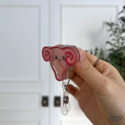 Layered side profile of the OBGYN shaker badge reel, highlighting the pink uterus design.