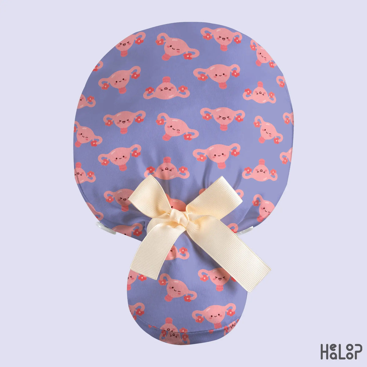 OBGYN Uterus Ponytail Scrub Cap in lavender with cute pink uterus illustrations, a cream ribbon bow and a back pouch for ponytails.