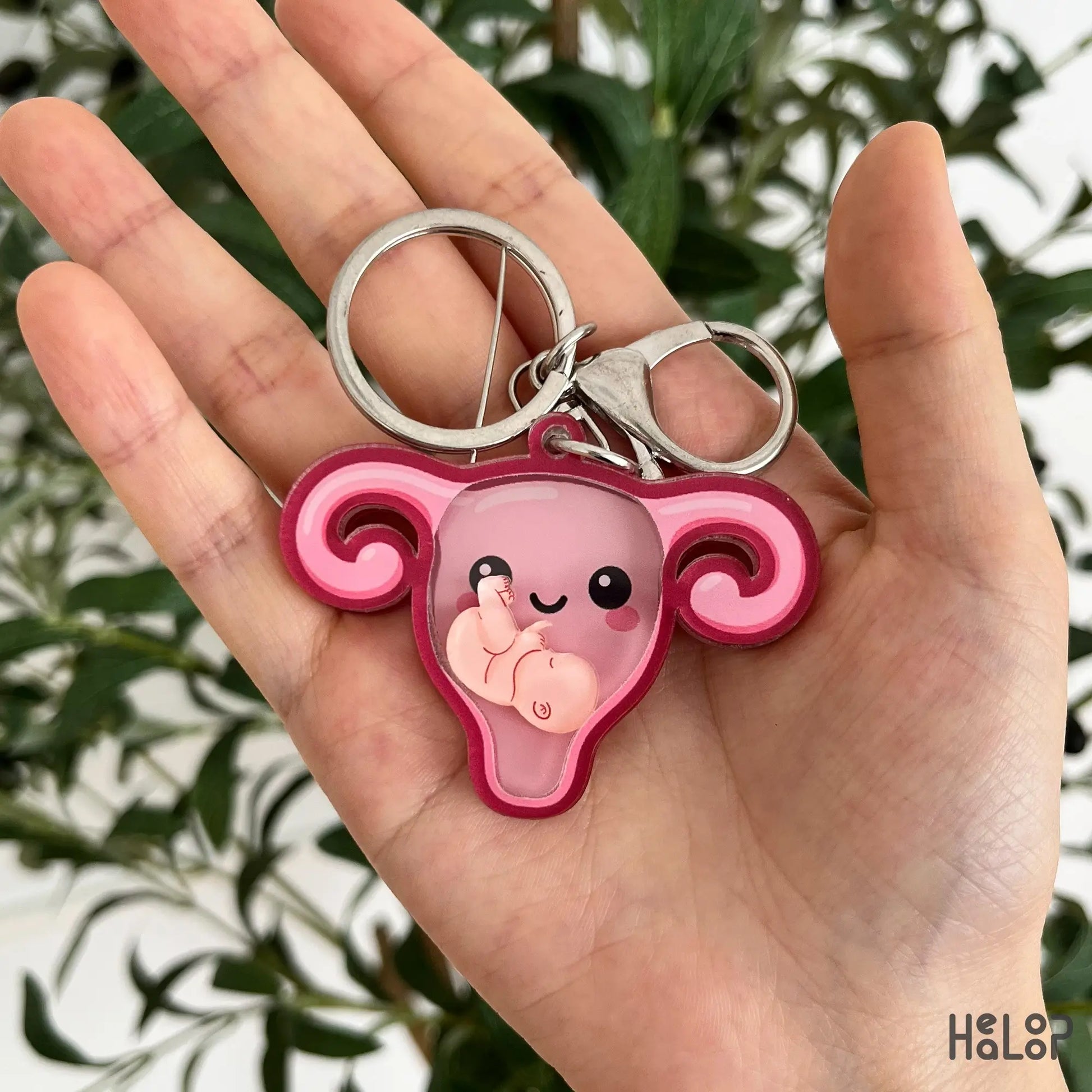 Healoop OBGYN uterus shaker keychain with moving baby charm displayed in hand