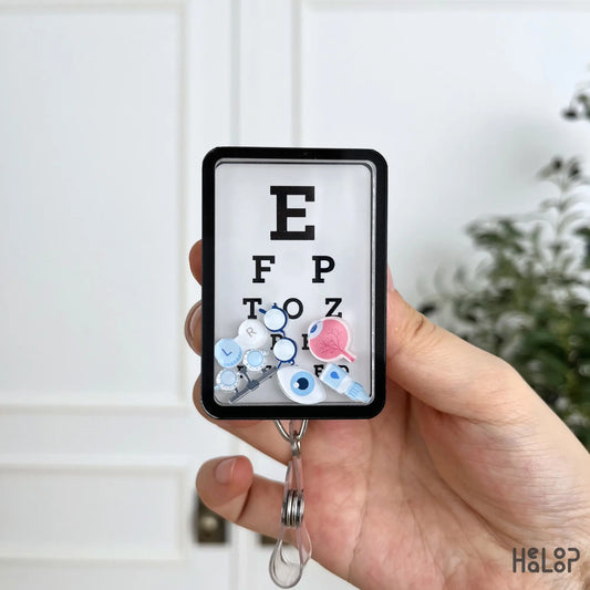Eye Chart Shaker Badge Reel with ophthalmology themed charms, a unique gift for optometrists and eye care staff.