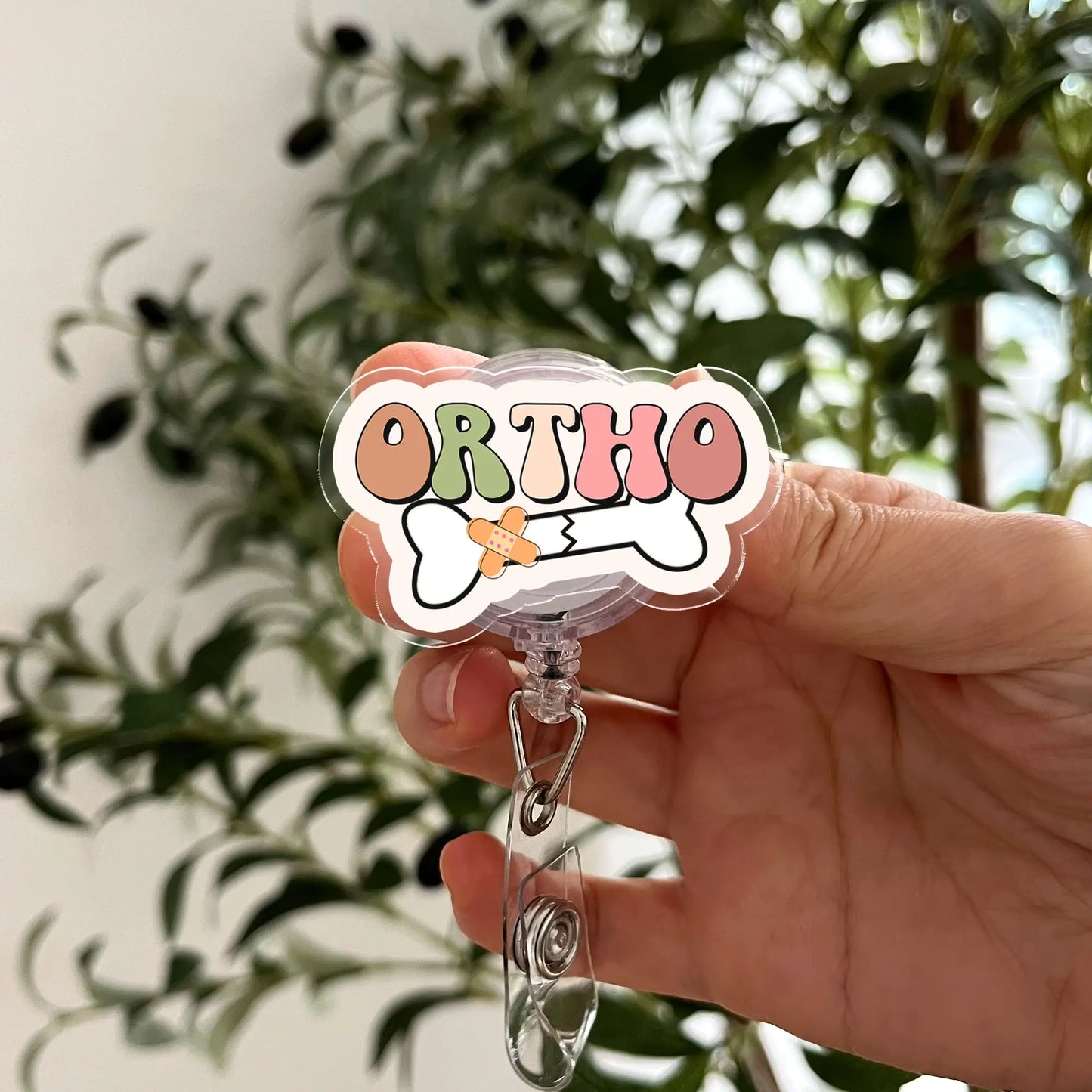 ORTHO acrylic badge reel with bone and bandage design – retractable ID clip for orthopedic nurses