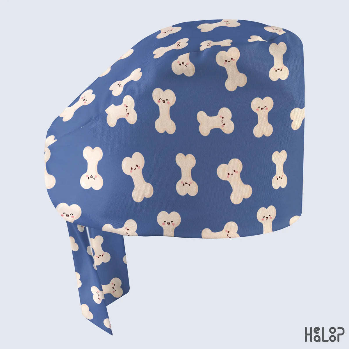 Side view of HEALOOP Ortho Bone Classic Scrub Cap featuring playful smiling bone characters on blue fabric, designed for orthopedic nurses and surgical professionals.