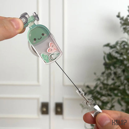 Oxygen tank shaker badge reel with retractable cord for healthcare professionals