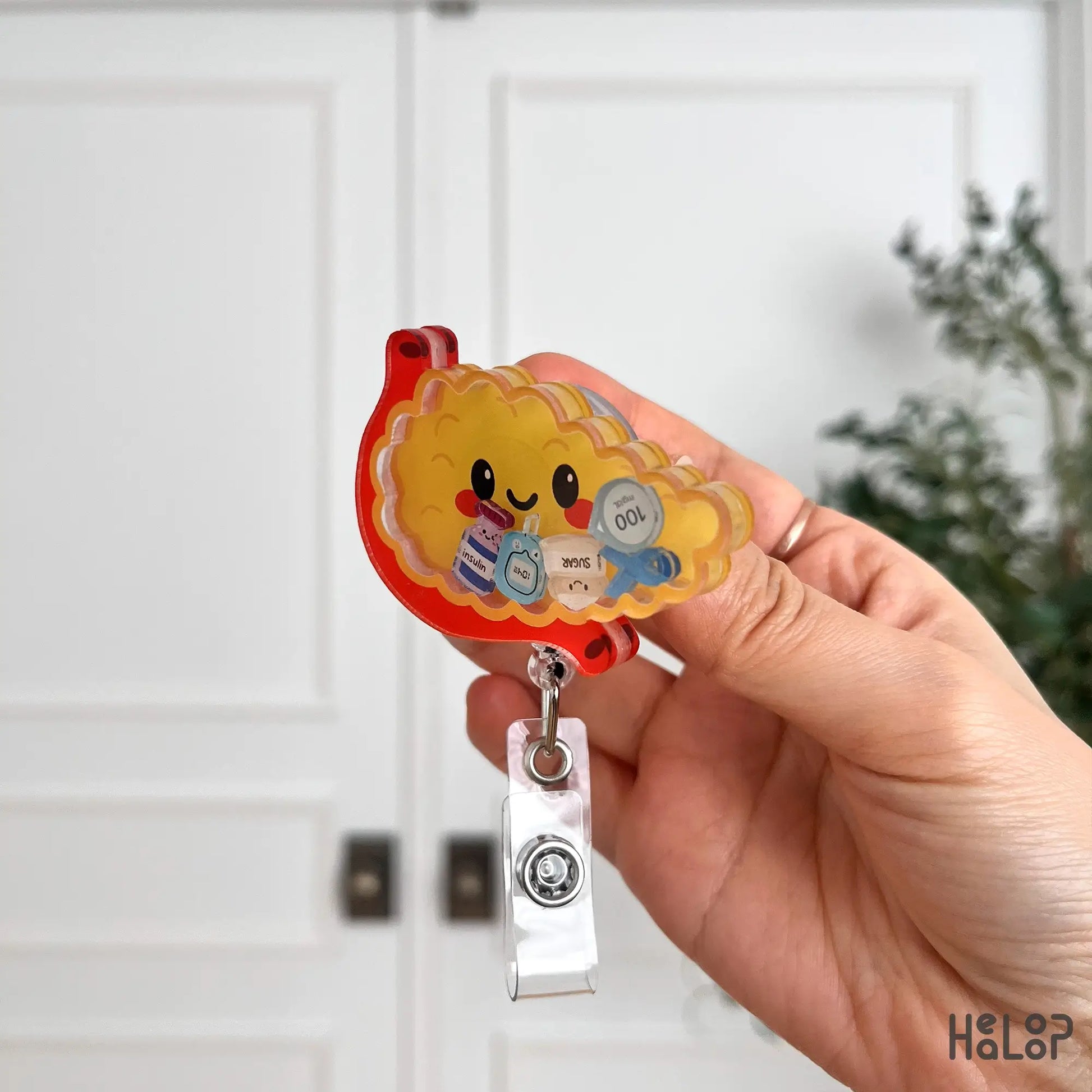 Side profile of pancreas shaped acrylic badge reel designed for medical professionals