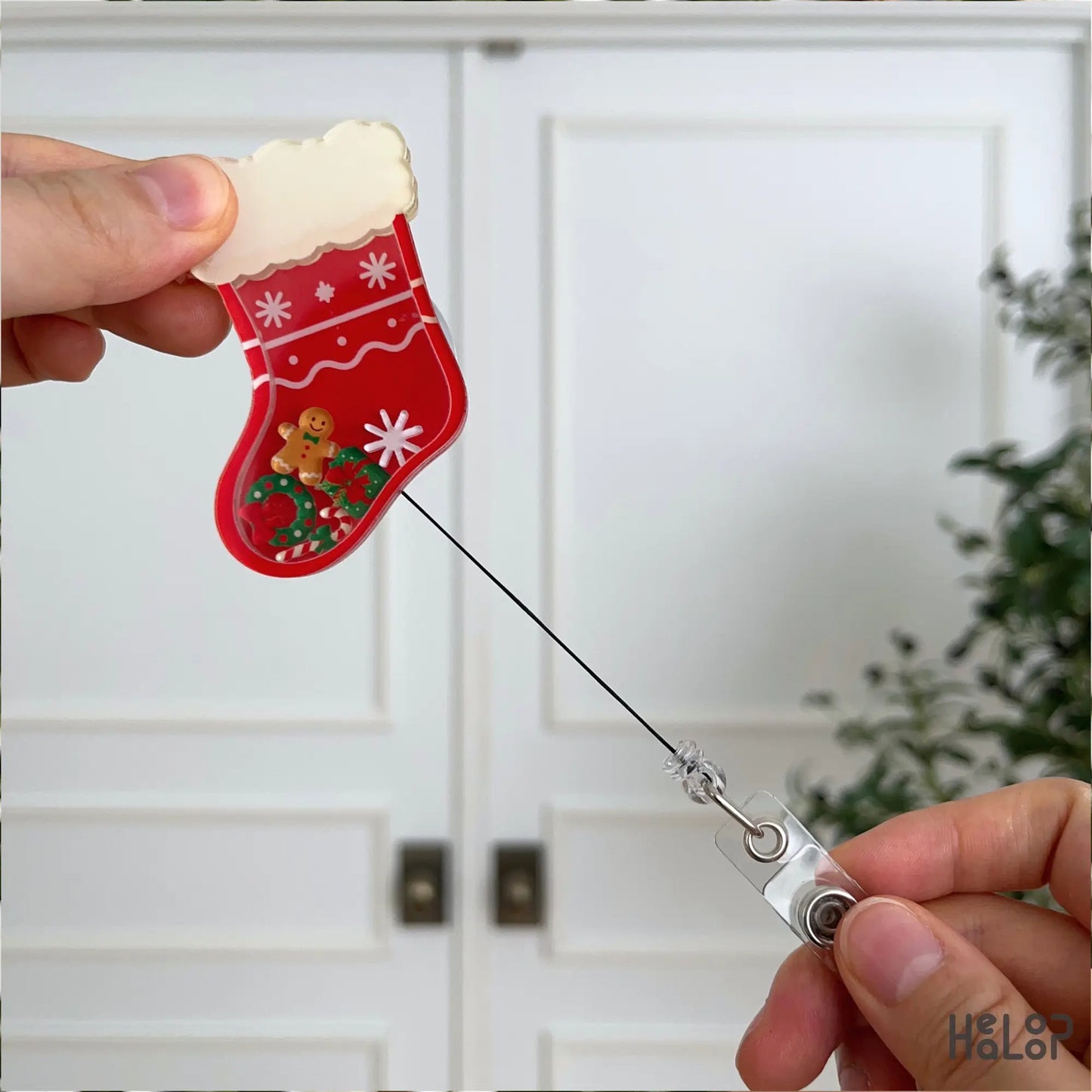 Custom Christmas stocking shaker badge reel with retractable badge cord and personalized name.