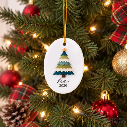 Personalized Liz ceramic and acrylic Christmas ornament hanging on a Christmas tree with holiday lights
