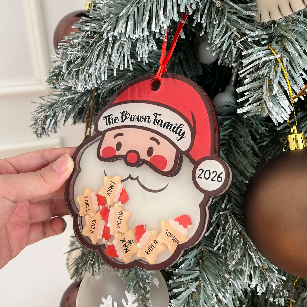 Personalized Santa shaker Christmas ornament featuring a custom family name, year, and individual family member name charms.