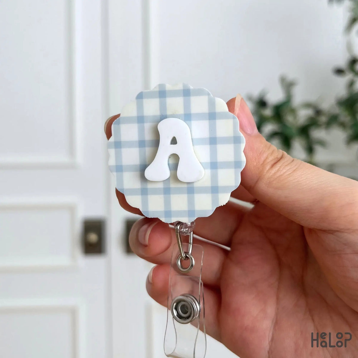 Personalized letter A badge reel with raised white initial and blue plaid background for an ID badge holder