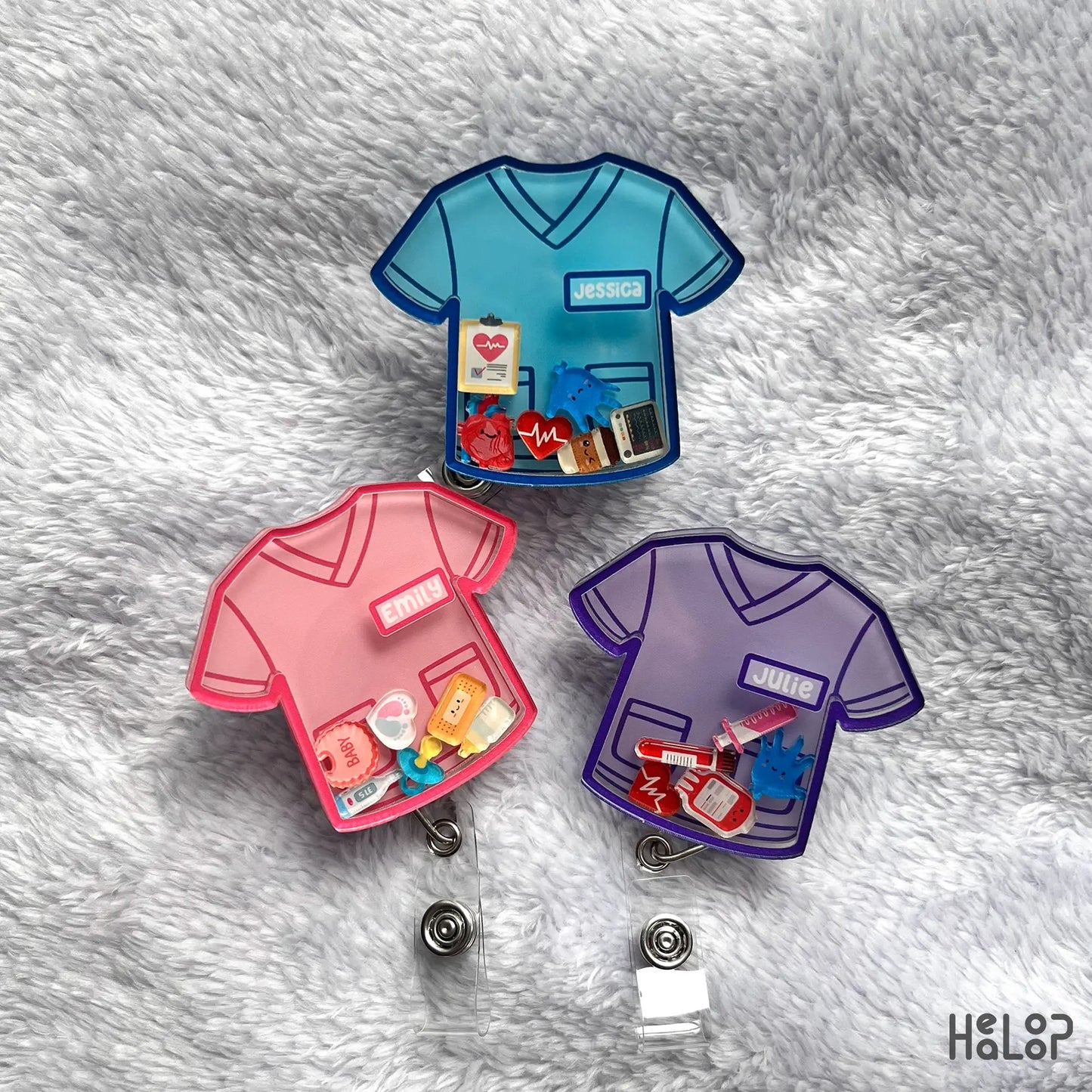 Group photo of personalized nurse scrub top shaker badge reels with different colors and charms