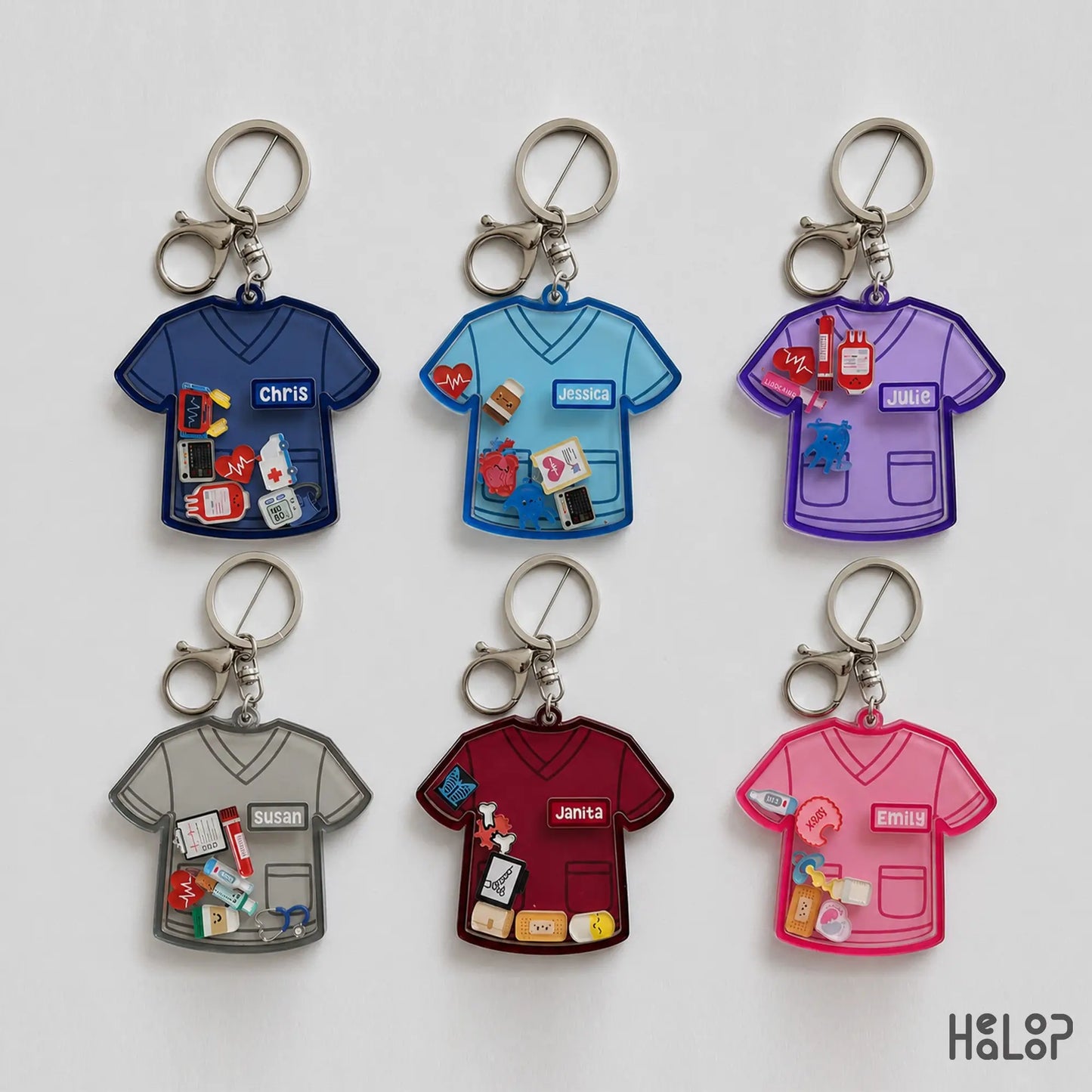 Collection of six personalized nurse shaker keychains in different scrub colors with custom names and medical charms.