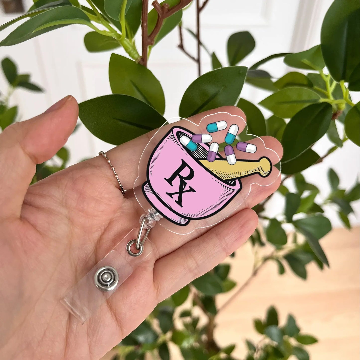 Pharmacist badge reel featuring pink RX bowl and colorful pills – perfect gift for pharmacy staff