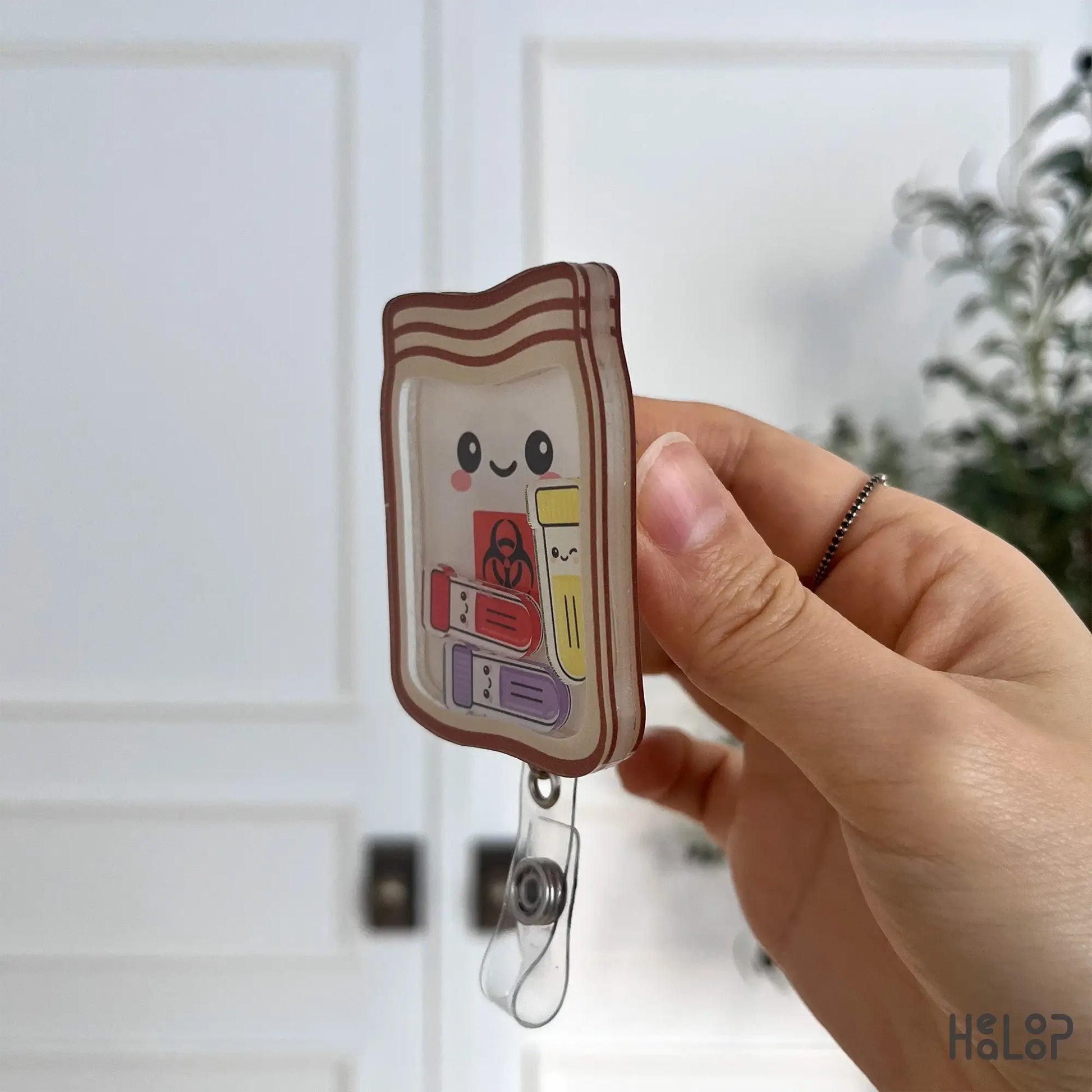 Layered acrylic side profile of the phlebotomist biohazard shaker badge reel.