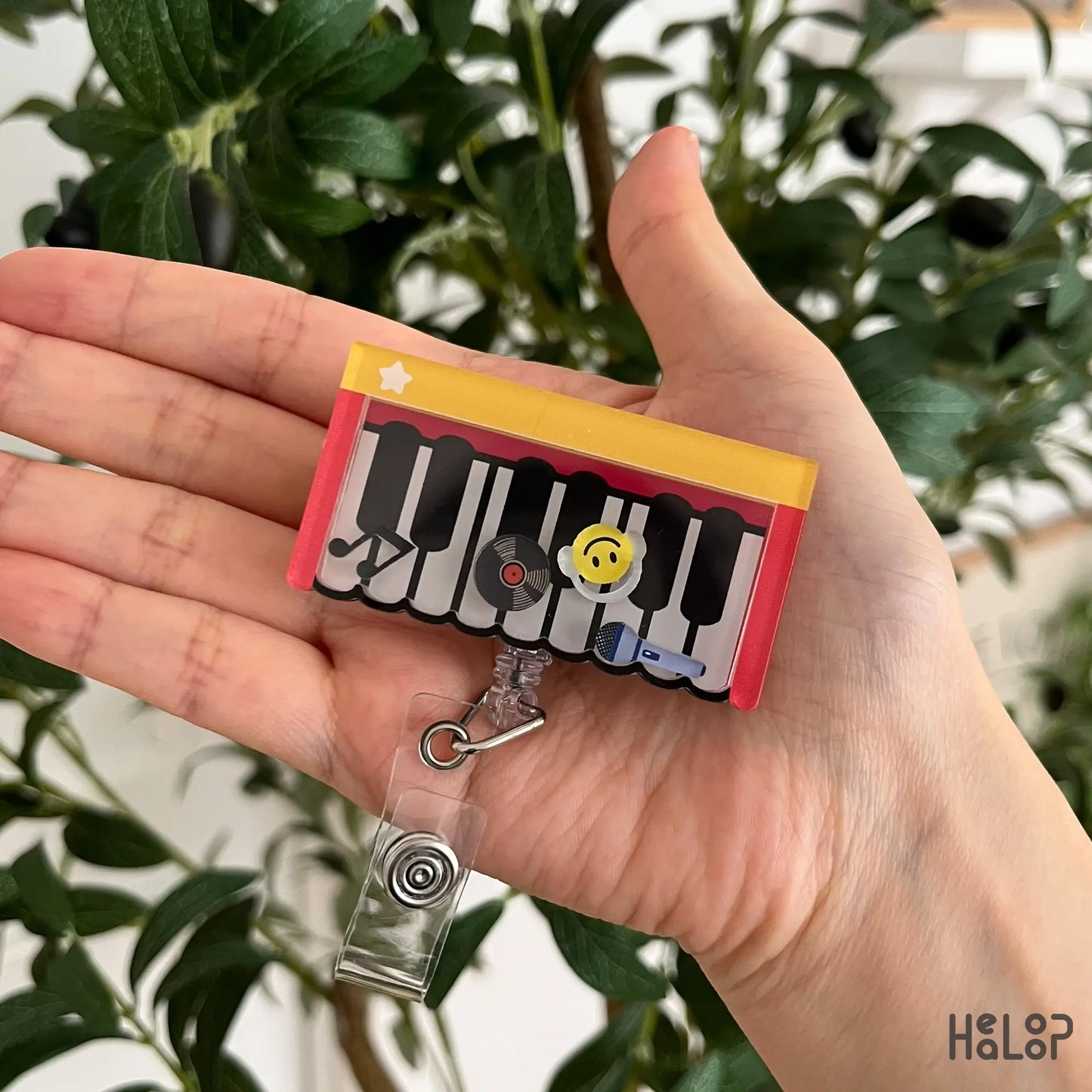 Cute Piano Shaker Badge Reel with movable music-themed charms including a smiley face, vinyl record, music note, and microphone, perfect for music teachers, musicians, and piano instructors.