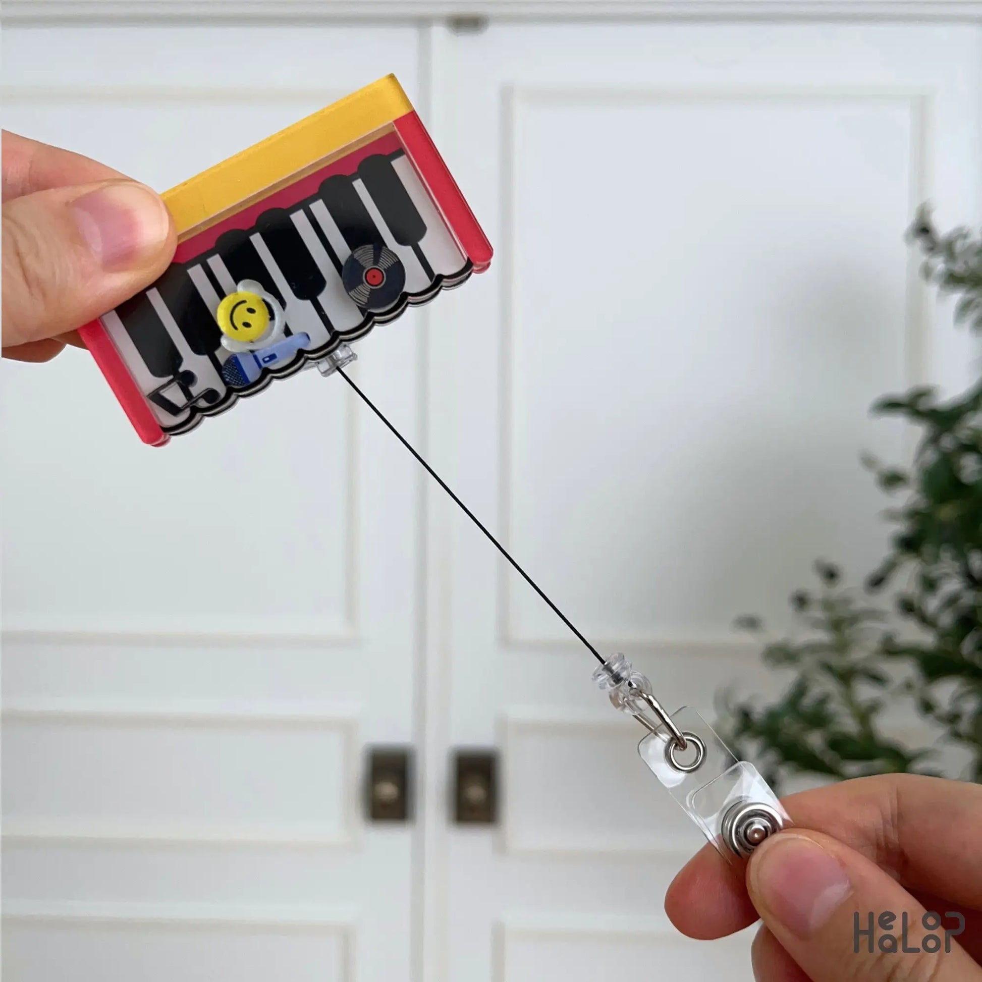 Retractable Piano acrylic shaker badge reel featuring interactive music-themed charms and a durable pull cord.