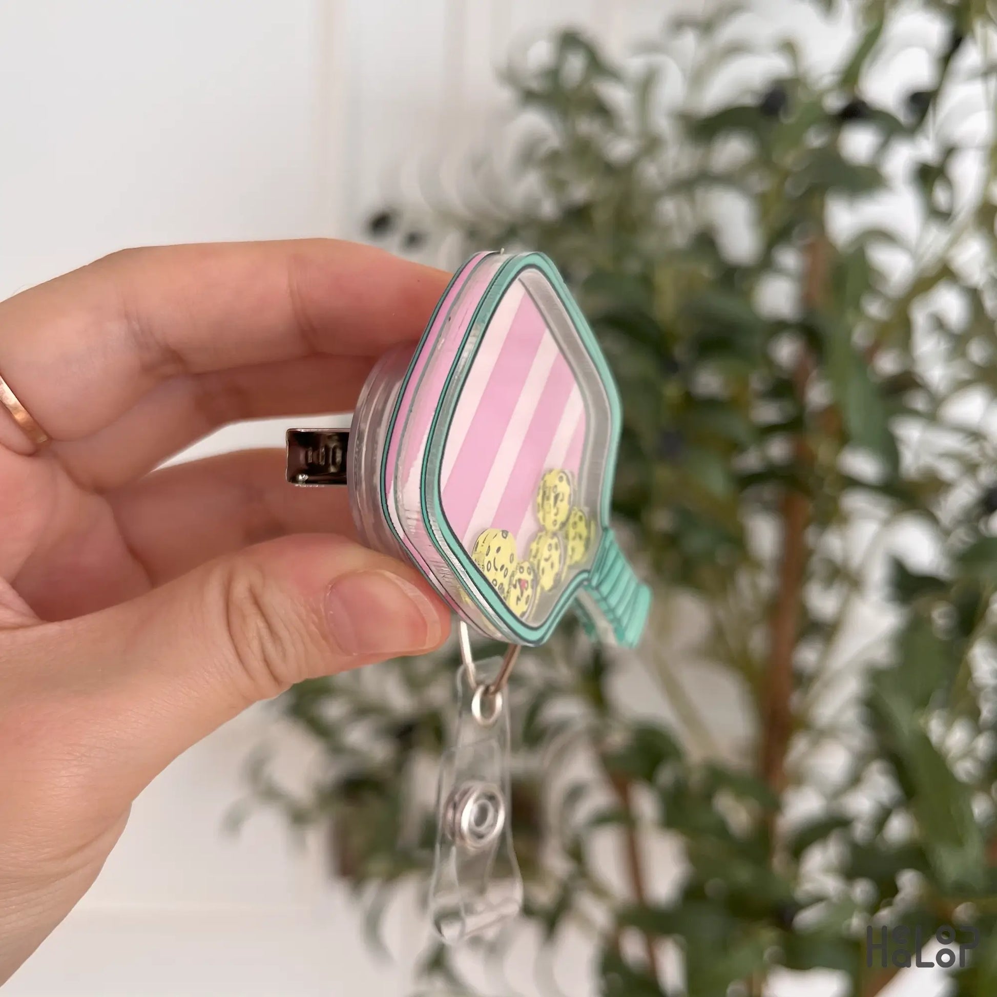Side view showing thickness and alligator clip of the pickleball badge reel