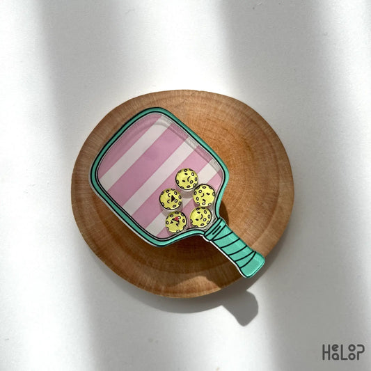 Pickleball shaker phone grip lying on desk showing charm design