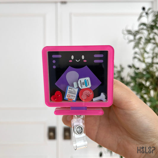 Front view of pink ultrasound badge reel with charms.