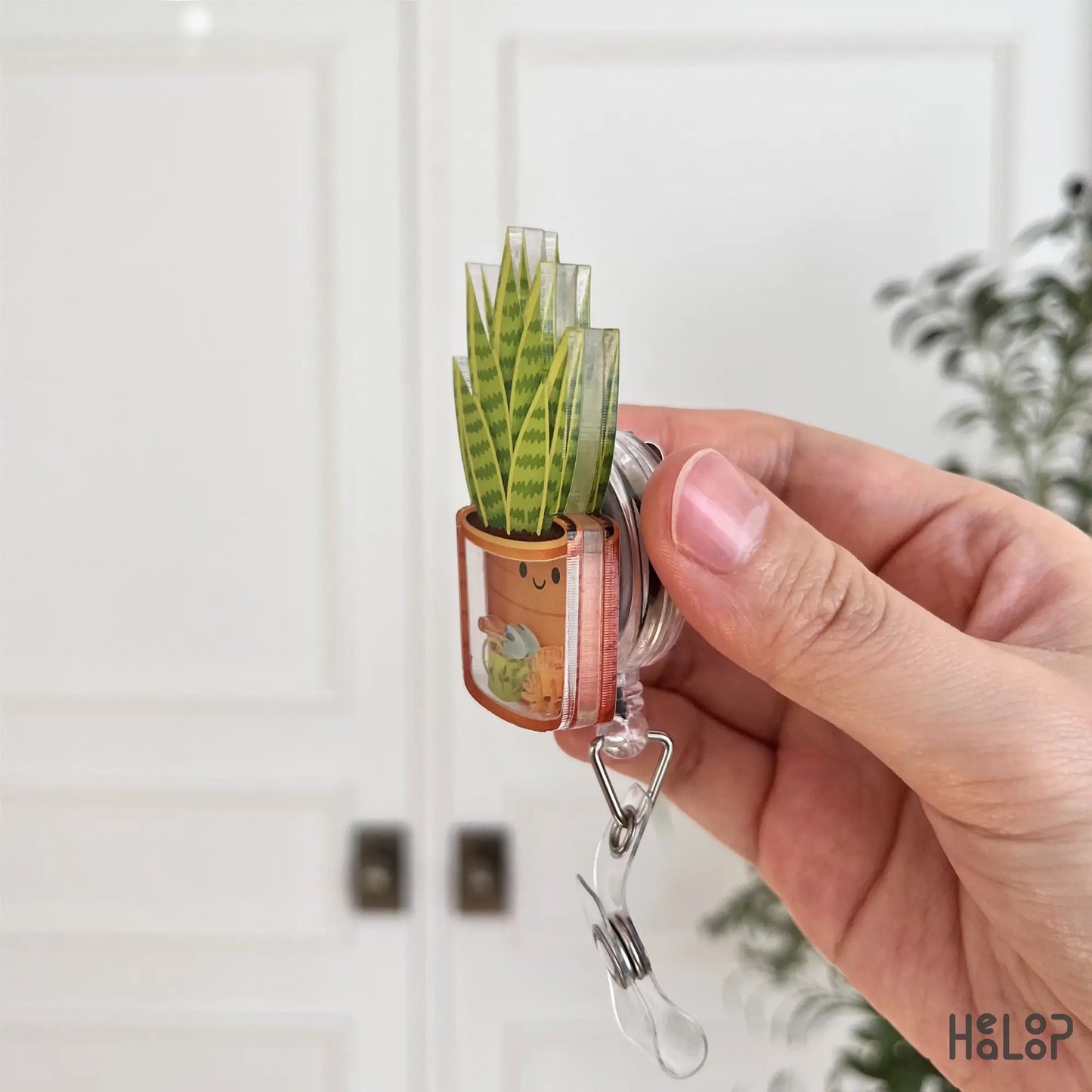 Acrylic layered plant shaker badge reel side view showing thickness and durable construction