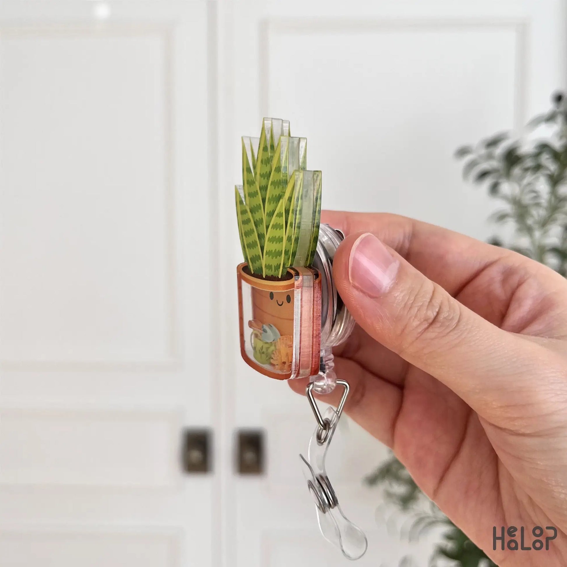 Acrylic layered plant shaker badge reel side view showing thickness and durable construction