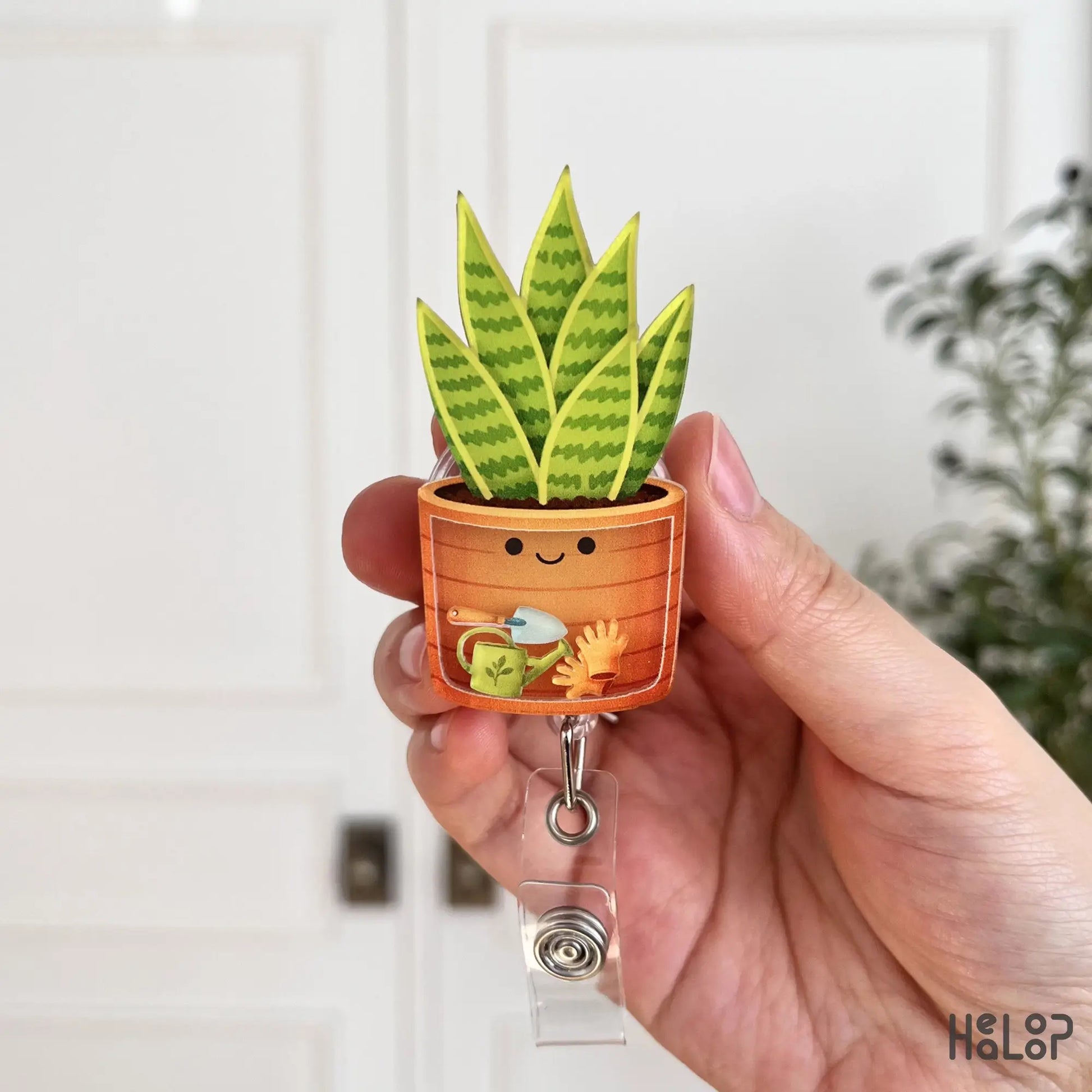 Front design of plant shaker badge reel with smiling pot illustration, unique nurse badge holder