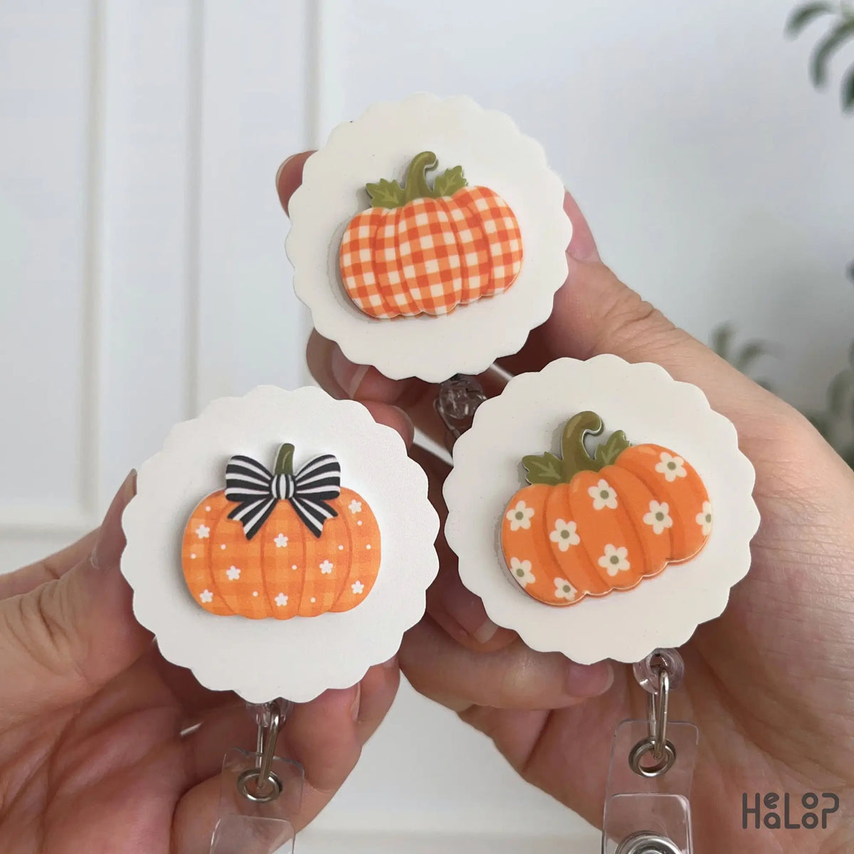 Three pumpkin badge holders featuring gingham, floral and bow designs for fall