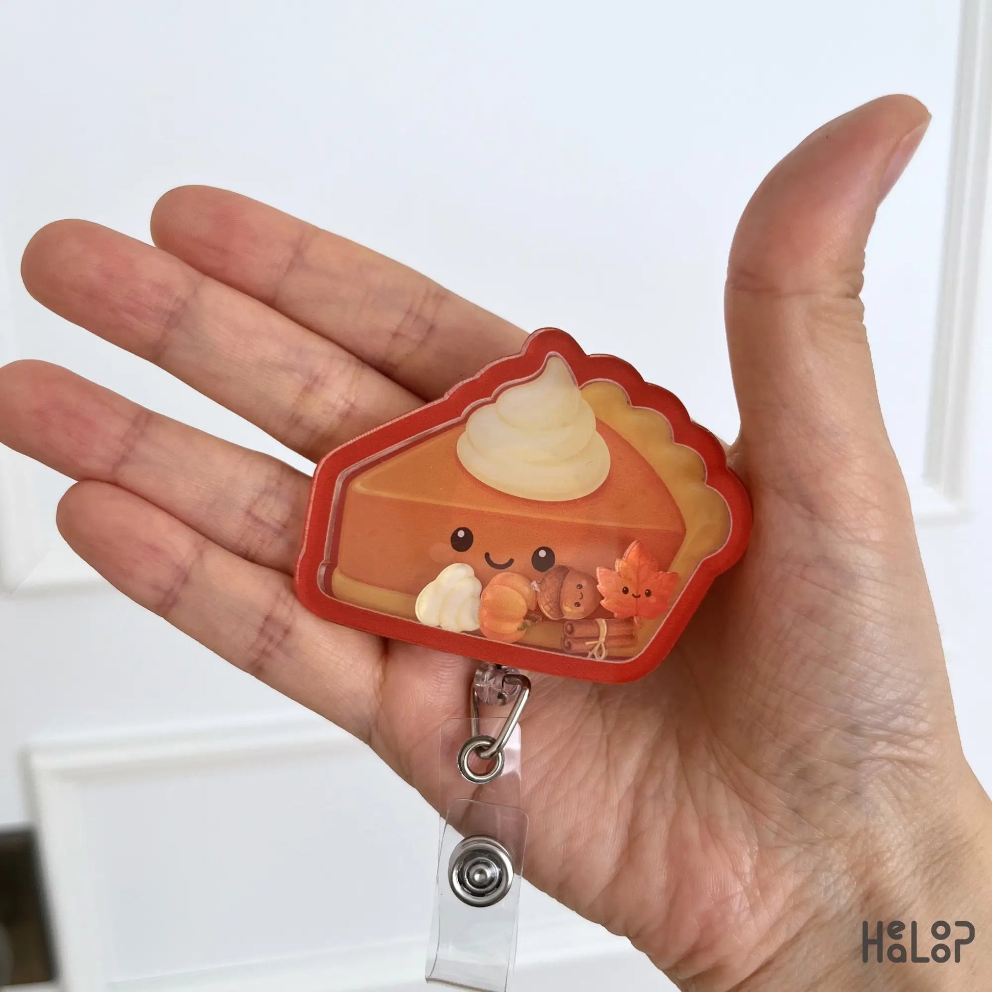 Cute Pumpkin Pie Shaker Badge Reel featuring a smiling pumpkin pie with whipped cream and fall shaker charms for nurses, healthcare workers, teachers, and Thanksgiving season.