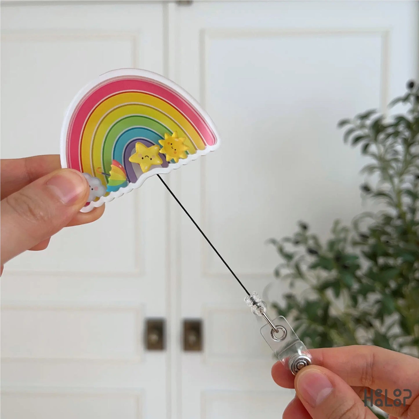 Retractable rainbow badge holder being extended, functional and cute nurse accessory