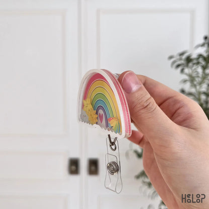 Layered acrylic rainbow shaker badge reel side view showing durable construction for daily use