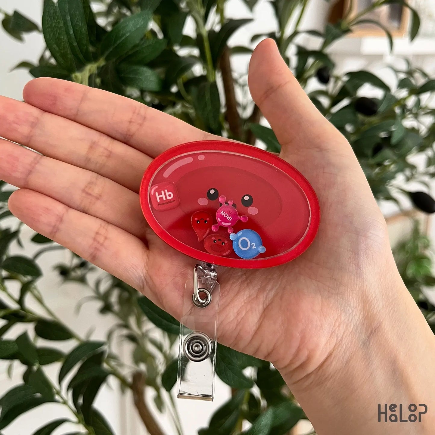 Cute Red Blood Cell Shaker Badge Reel with movable Hb, iron, O₂, and red blood cell charms, perfect for hematology professionals, nurses, laboratory scientists, and phlebotomists.