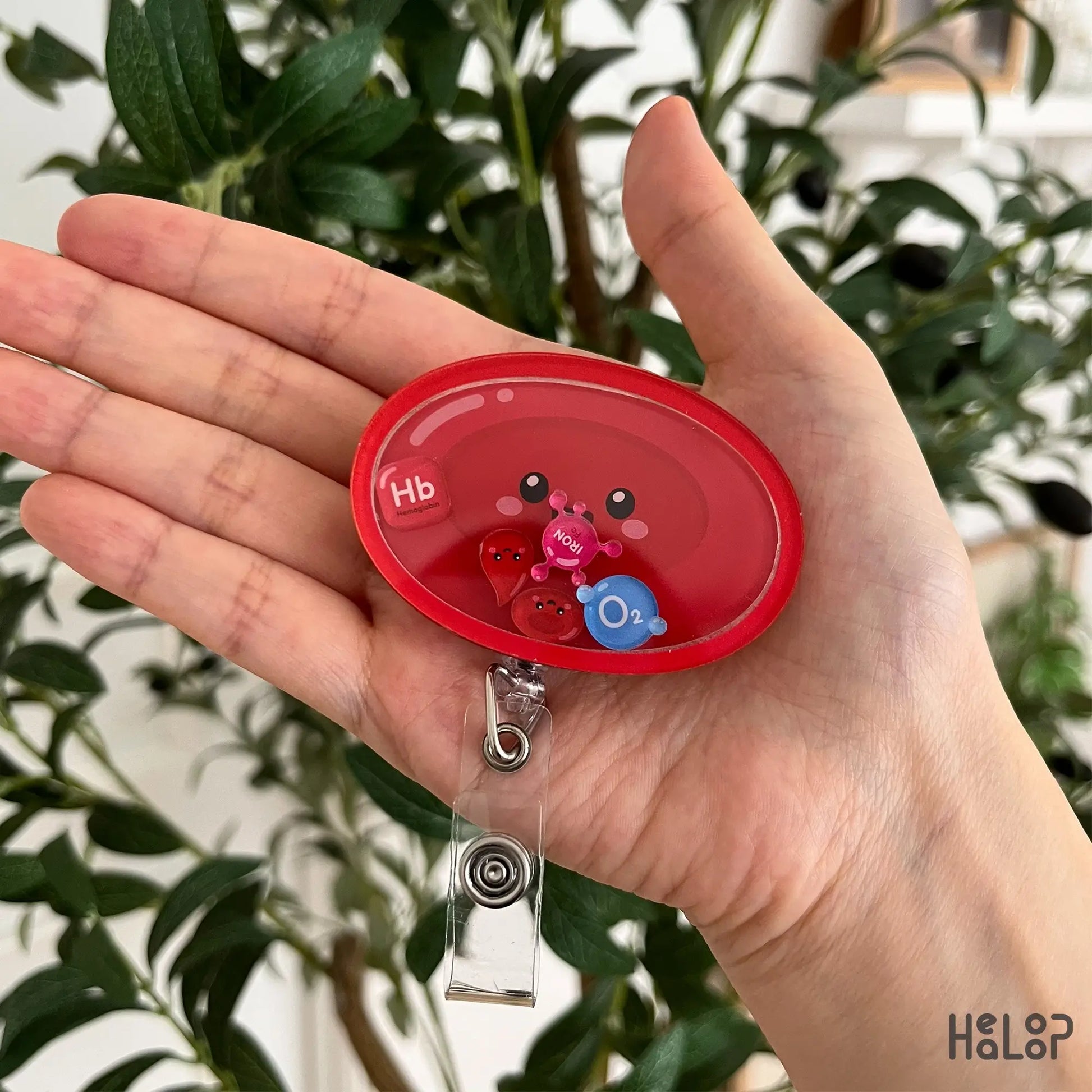 Cute Red Blood Cell Shaker Badge Reel with movable Hb, iron, O₂, and red blood cell charms, perfect for hematology professionals, nurses, laboratory scientists, and phlebotomists.