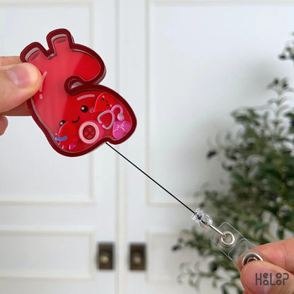 Retractable aorta shaker badge holder with extended cord and colorful cardiology-inspired charms.